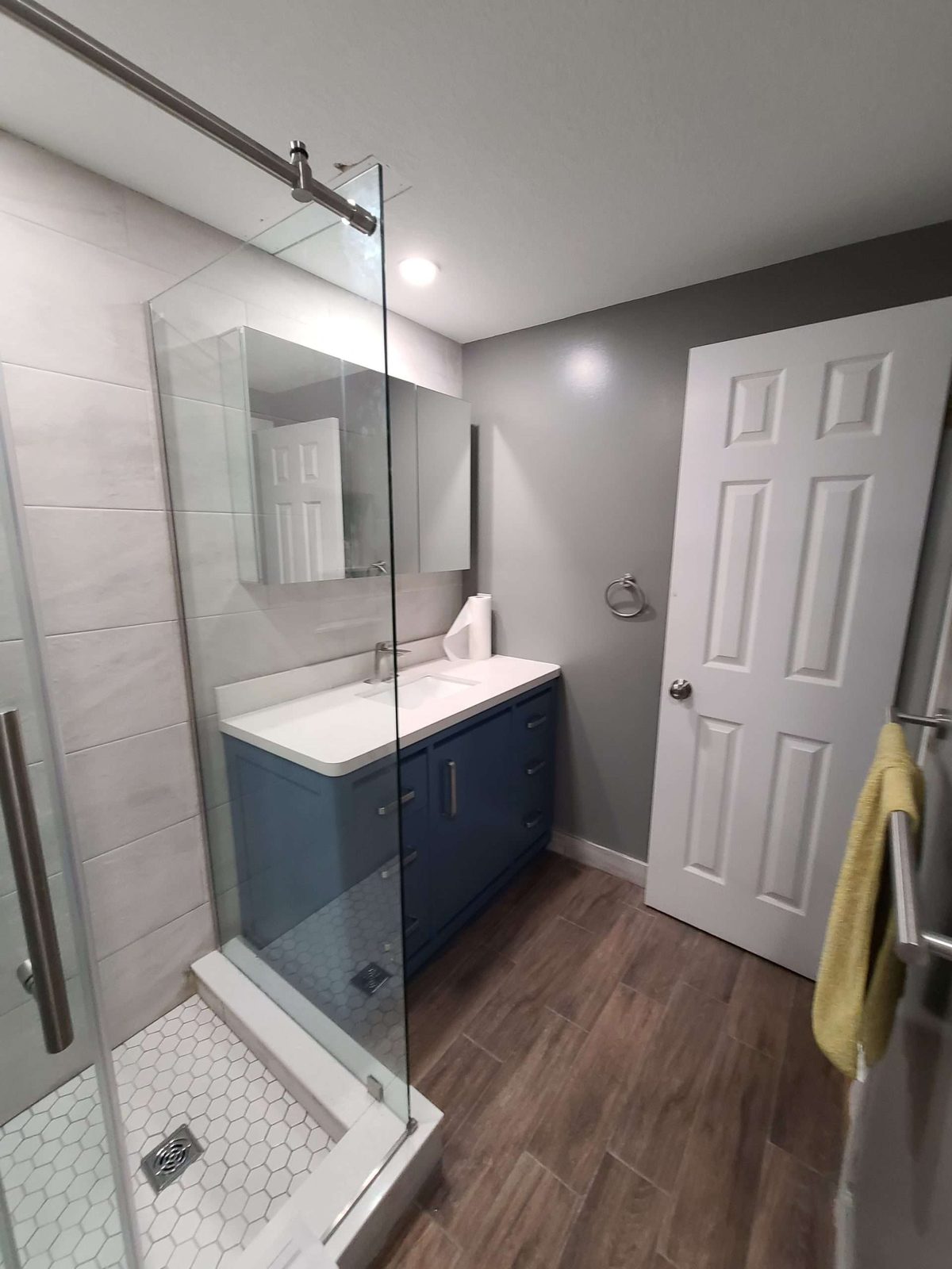 Walk-in shower with barn door in a renovated bathroom