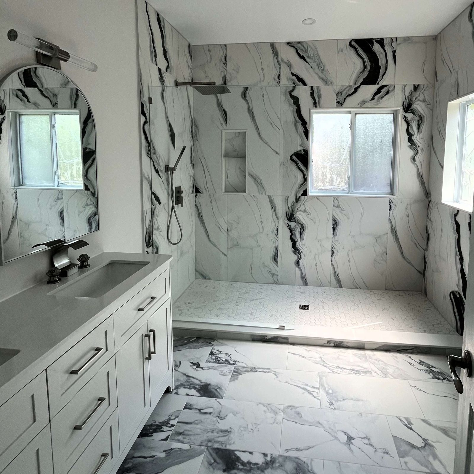 Marble ensuite bathroom with floating vanity and glass shower